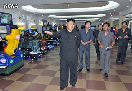 Kim Jong Un walks past video games in this KCNA photo