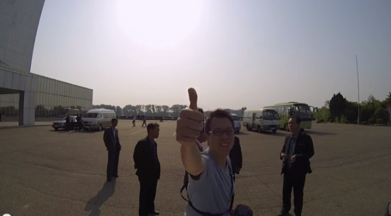 Aran Pan gives a thumbs up at the beginning of his GoPro drive through Pyongyang video.
