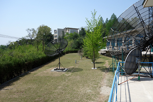 An image taken by Reinin Shiino and released by Kyodo News showing satellite dishes in the Japanese Village compound in North Korea (Reinin Shiino/Kyodo News)