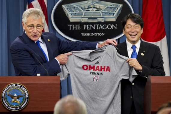 U.S. Defense Secretary Chuck Hagel, left, gives Japanese Defense Minister Itsunori Onodera a University of Nebraska tennis shirt at the Pentagon, July 11, 2014. (Photo: DoD/Casper Manlangit)
