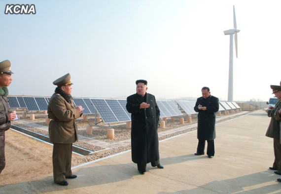 Kim Jong Un in front of solar panels in an image carried on the state KCNA newswire